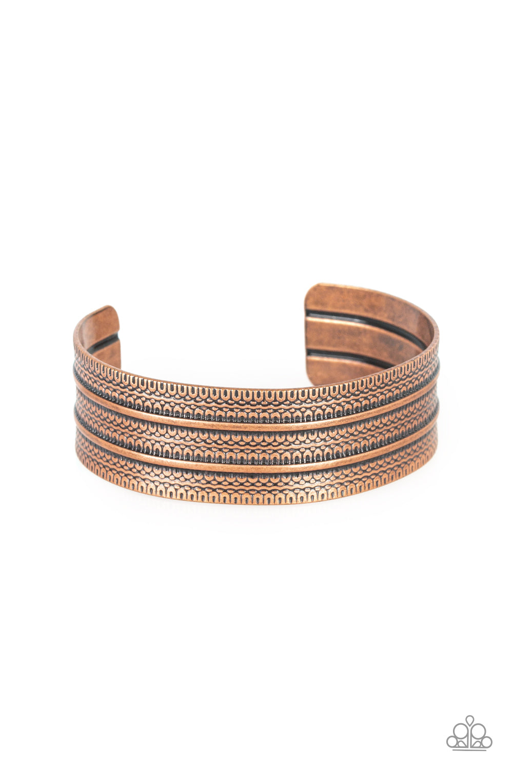 Stamped in tribal inspired patterns, an antiqued copper cuff wraps around the wrist for an indigenous look.