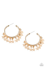 Load image into Gallery viewer, A shiny collection of gold star charms trickles from the bottom of a classic gold hoop, creating a stellar fringe. Earring attaches to a standard post fitting. Hoop measures approximately 1 1/4&quot; in diameter. 
