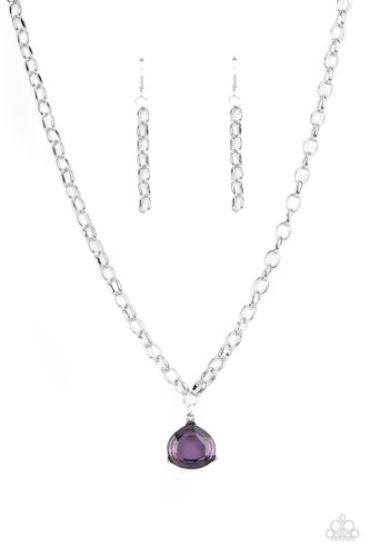 An oversized glassy purple gem is pressed into a pronged silver fitting at the bottom of a chunky silver chain, creating a dramatic pendant below the collar. Features an adjustable clasp closure.