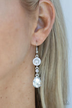 Load image into Gallery viewer, A silver frame dotted in glassy white rhinestones, a solitaire white rhinestone, and an oversized white teardrop gem delicately link into a graceful lure. Earring attaches to a standard fishhook fitting.
