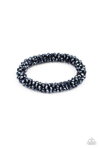 Sparkling with dramatic brilliance, a collection of dainty faceted blue beads are threaded along a woven stretchy band creating a stunning statement around the wrist.