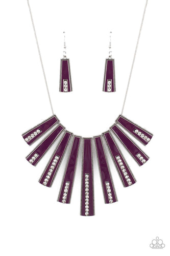 Encased in daintily dotted silver frames, a row of flared silver bars painted in a glossy purple, fans out across the collar. A column of sparkling white rhinestones rises from the bottom of each frame, creating a dramatically deco finish as they sway from a round silver chain. Features an adjustable clasp closure.