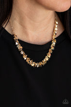 Load image into Gallery viewer, A glistening collection of dainty gold star charms delicately cluster on a classic gold chain, creating a stellar fringe below the collar. Features an adjustable clasp closure
