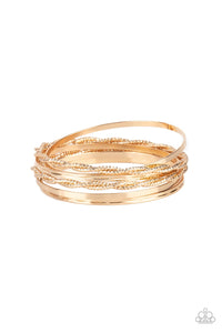 Infused with plain gold bangles, pairs of twisted and faceted gold bracelets stack across the wrist for endless shimmer.  Sold as one set of six bracelets.