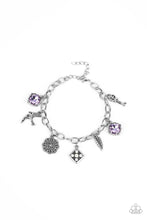 Load image into Gallery viewer, Sparkling purple gems, a floral medallion, a bird in flight, and a fluttering feather dangle from a delicate silver chain as they coalesce into a whimsical charm bracelet. Features an adjustable clasp closure. 
