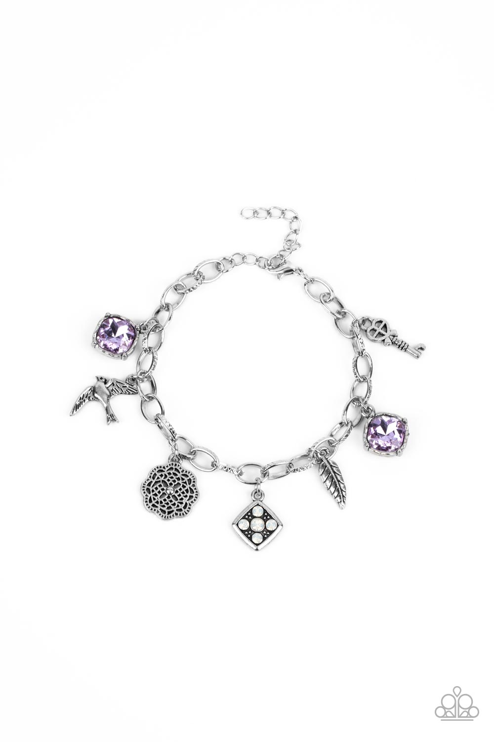 Sparkling purple gems, a floral medallion, a bird in flight, and a fluttering feather dangle from a delicate silver chain as they coalesce into a whimsical charm bracelet. Features an adjustable clasp closure. 