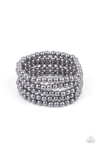 Stacked layers of luminous grey pearl-like beads are threaded along stretchy bands creating a subtly indulgent allure around the wrist.