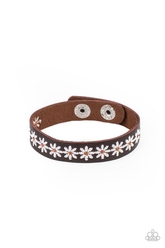 Featuring dainty brown centers, a casual row of white flowers is stitched across the front of a skinny brown leather band for a seasonal look. Features an adjustable snap closure.