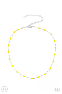 Dainty silver beads and cylindrical Illuminating beads delicately link around the neck, creating a minimalist inspired pop of color. Features an adjustable clasp closure.