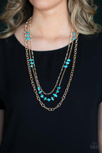 Load image into Gallery viewer, Infused with sections of refreshing turquoise stones, a trio of mismatched gold chains layer down the chest for a dash of earthy refinement. Features an adjustable clasp closure. 
