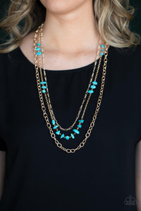 Infused with sections of refreshing turquoise stones, a trio of mismatched gold chains layer down the chest for a dash of earthy refinement. Features an adjustable clasp closure. 