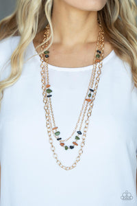 Infused with sections of earthy brown, black, and green stones, a trio of mismatched gold chains layer down the chest for a dash of rustic refinement. Features an adjustable clasp closure.