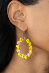 Dotted with white beaded centers, a dainty collection of Illuminating seed beaded floral frames are threaded along a wire hoop for a fabulous floral fashion. Earring attaches to a standard fishhook fitting.