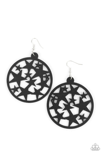 An oversized round black wooden frame is filled with a cosmos of cut-out black stars creating a whimsical statement. Earring attaches to a standard fishhook fitting.