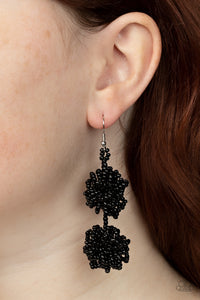Strands of shiny black seed beads delicately knot into an elegantly clustered lure, creating a stellar modern look. Earring attaches to a standard fishhook fitting. 