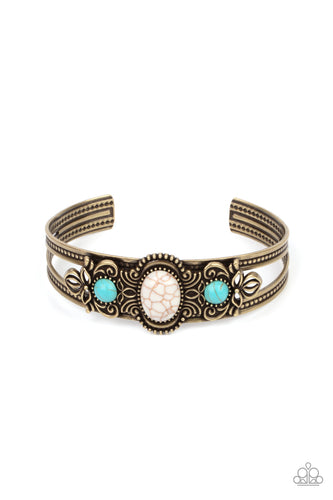 Dotted with a pair of turquoise stone beads, brass floral filigree blooms out from an oval white stone centerpiece atop a studded brass cuff.  Sold as one individual bracelet.