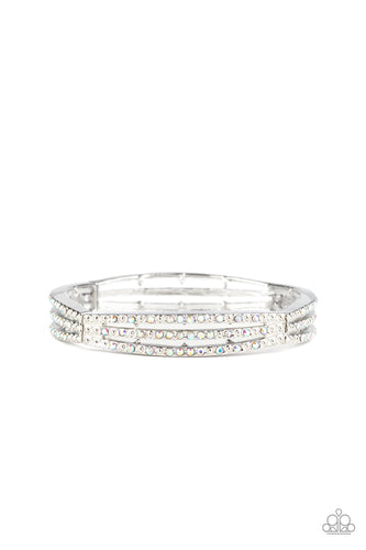 Sporadically dotted in rows of iridescent rhinestones and shiny silver studs, stacked silver frames are threaded along a stretchy band around the wrist for a refined look.  Sold as one individual.