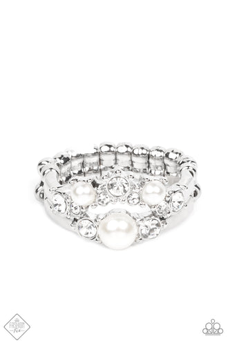 Featuring pronged silver fittings, a bubbly collection of white pearls and glassy white rhinestones coalesce into two effervescent bands across the finger. Features a dainty stretchy band for a flexible fit.  Sold as one individual ring.  Fashion Fix New Kit