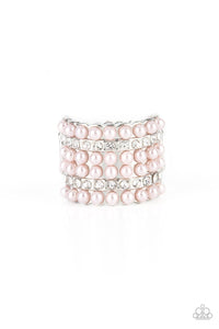 Dainty rows of bubbly pink pearls and glassy white rhinestones alternate across the front of a thick silver band, creating a vintage inspired statement piece. Features a stretchy band for a flexible fit. 