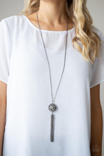 Load image into Gallery viewer, Infused with gunmetal studded fittings, a glittery collection of sparkly white rhinestones coalesce into a dramatic pendant at the bottom of a lengthened gunmetal chain. Capped in a rhinestone dotted frame, a shimmery gunmetal tassel streams out from the blinding pendant for a flirtatious finish. Features an adjustable clasp closure.
