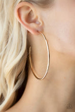 Load image into Gallery viewer, Featuring a high sheen, a polished gold hoop stands out in a mega way creating a trendy display as it wraps around the ear. Earring attaches to a standard post fitting. Hoop measures approximately 3&quot; in diameter. 
