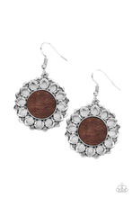 Load image into Gallery viewer, Layers of shiny silver petals bloom from a flat brown wooden center, creating a whimsically rustic display. Earring attaches to a standard fishhook fitting.
