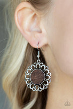 Load image into Gallery viewer, Layers of shiny silver petals bloom from a flat brown wooden center, creating a whimsically rustic display. Earring attaches to a standard fishhook fitting.
