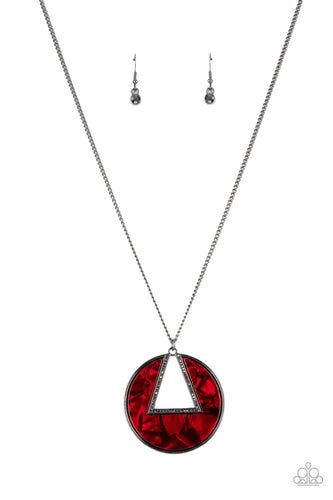 An airy hematite encrusted triangular frame is pressed into a gunmetal ring adorned in a red shell-like frame. The colorful pendant swings from the bottom of a classic gunmetal chain, creating a modern display. Features an adjustable clasp closure. 
