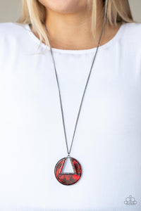 An airy hematite encrusted triangular frame is pressed into a gunmetal ring adorned in a red shell-like frame. The colorful pendant swings from the bottom of a classic gunmetal chain, creating a modern display. Features an adjustable clasp closure. 