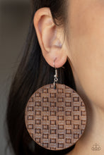 Load image into Gallery viewer, Featuring a faux woven pattern a leathery brown frame swings from the ear for an earthy artisan fashion. Earring attaches to a standard fishhook fitting. 
