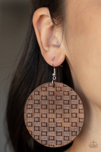 Featuring a faux woven pattern a leathery brown frame swings from the ear for an earthy artisan fashion. Earring attaches to a standard fishhook fitting. 