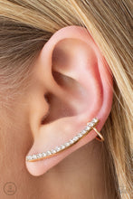 Load image into Gallery viewer, A dainty row of glassy white rhinestones are encrusted along a glistening gold bar that swoops up the ear for a sparkly style. Features a dainty cuff attached to the top for a secure fit.  Sold as one pair of ear crawlers.
