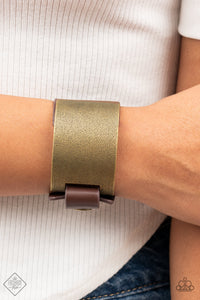 A curved brass panel, coated in antiqued texture, attaches to a wide brown leather band with brass snaps resulting in an edgy industrial element around the wrist. Features an adjustable snap closure.  Sold as one individual bracelet.