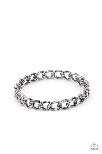 A single strand of bold gunmetal chain links into a solid bangle around the wrist for an intense industrial fashion.