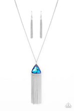 Load image into Gallery viewer, Featuring an iridescent UV shimmer, an oversized blue triangular gem swings from the bottom of a lengthened silver chain. A curtain of silver chains streams out from the bottom of the sparkly pendant, adding playful movement to the glamorous statement piece. Features an adjustable clasp closure.
