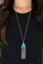 Load image into Gallery viewer, Featuring an iridescent UV shimmer, an oversized blue triangular gem swings from the bottom of a lengthened silver chain. A curtain of silver chains streams out from the bottom of the sparkly pendant, adding playful movement to the glamorous statement piece. Features an adjustable clasp closure.
