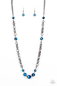 Featuring an oil spill iridescence, faceted metallic blue beads adorn sections of chunky gunmetal chains across the chest for a gritty glamorous fashion. Features an adjustable clasp closure.