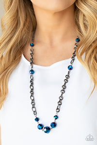 Featuring an oil spill iridescence, faceted metallic blue beads adorn sections of chunky gunmetal chains across the chest for a gritty glamorous fashion. Features an adjustable clasp closure.