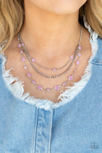 Infused with glassy Pale Rosette beaded strands, layers of mismatched silver chains drape below the collar for an ethereal pop of color. Features an adjustable clasp closure. 