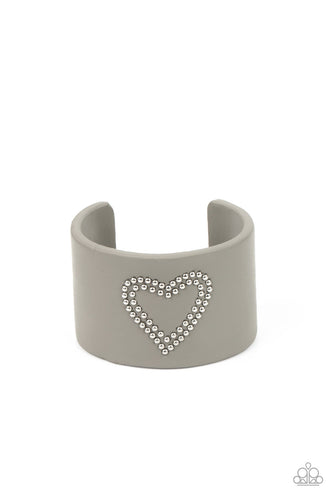 The center of an Ultimate Gray leather cuff is studded in a charming heart pattern, creating a rustically romantic look around the wrist.  Sold as one individual bracelet.