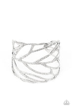 Load image into Gallery viewer, Hammered in rustic details, an airy silver feather wraps around the wrist, creating a seasonal cuff.
