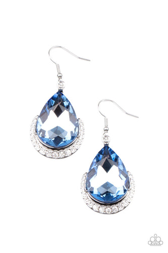 Dotted in white rhinestones, a dainty silver bar curves around the bottom of a dramatically oversized blue teardrop rhinestone for a glamorous fashion. Earring attaches to a standard fishhook fitting. 