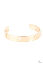 Load image into Gallery viewer, Airy gold stars are cutout along a classic gold cuff, creating a stellar centerpiece around the wrist.
