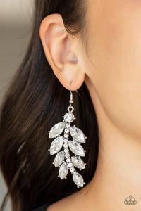 Oversized marquise cut white rhinestones fan out from a curved silver bar encrusted in glassy white rhinestones, resulting into a glamorously leafy statement piece. Earring attaches to a standard fishhook fitting.
