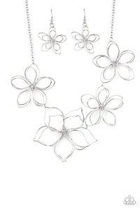 Shiny silver wire delicately twists into oversized blossoms. Varying in size, the airy floral frames delicately link into an asymmetrical display as the layered frames elegantly pop beneath the collar. Features an adjustable clasp closure.