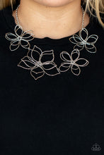 Load image into Gallery viewer, Shiny silver wire delicately twists into oversized blossoms. Varying in size, the airy floral frames delicately link into an asymmetrical display as the layered frames elegantly pop beneath the collar. Features an adjustable clasp closure.
