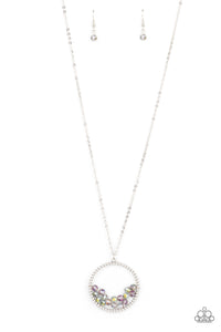 A cluster of metallic flecked and iridescent crystal-like beads are threaded along dainty silver wire along the bottom of a textured silver hoop, creating a stellar pendant at the bottom of a lengthened silver chain. Features an adjustable clasp closure.