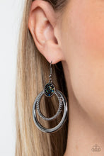 Load image into Gallery viewer, Smooth and textured silver hoops connect to the bottom of a silver fitting embellished in glitzy oil spill and hematite rhinestones, creating a dizzying lure. Earring attaches to a standard fishhook fitting.
