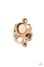 Load image into Gallery viewer, A collection of sparkling champagne-colored gems in varying sizes, accented by a single white rhinestone, forms an asymmetrical cluster atop the finger. Set in sleek gold frames over airy gold bands, the brilliant gems demand full attention. Features a stretchy band for a flexible fit. 
