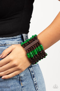 Held together by rectangular wooden frames, rows of brown wooden and distressed Leprechaun discs are threaded along stretchy bands around the wrist for a seasonal pop of color around the wrist.